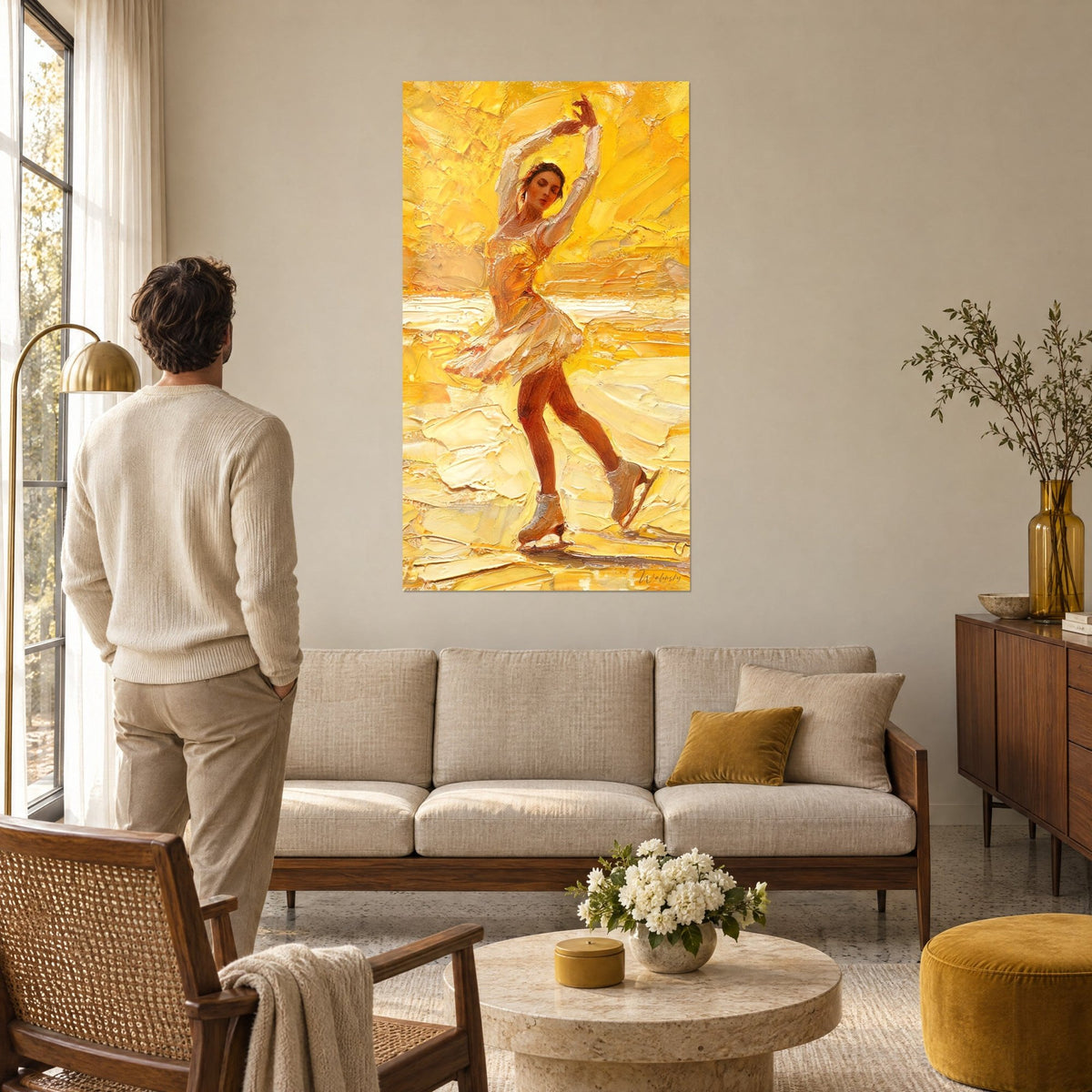 Wall art golden figure skater with arms raised, cream skirt and amber ice, man seen from behind above a sofa in a bright living room