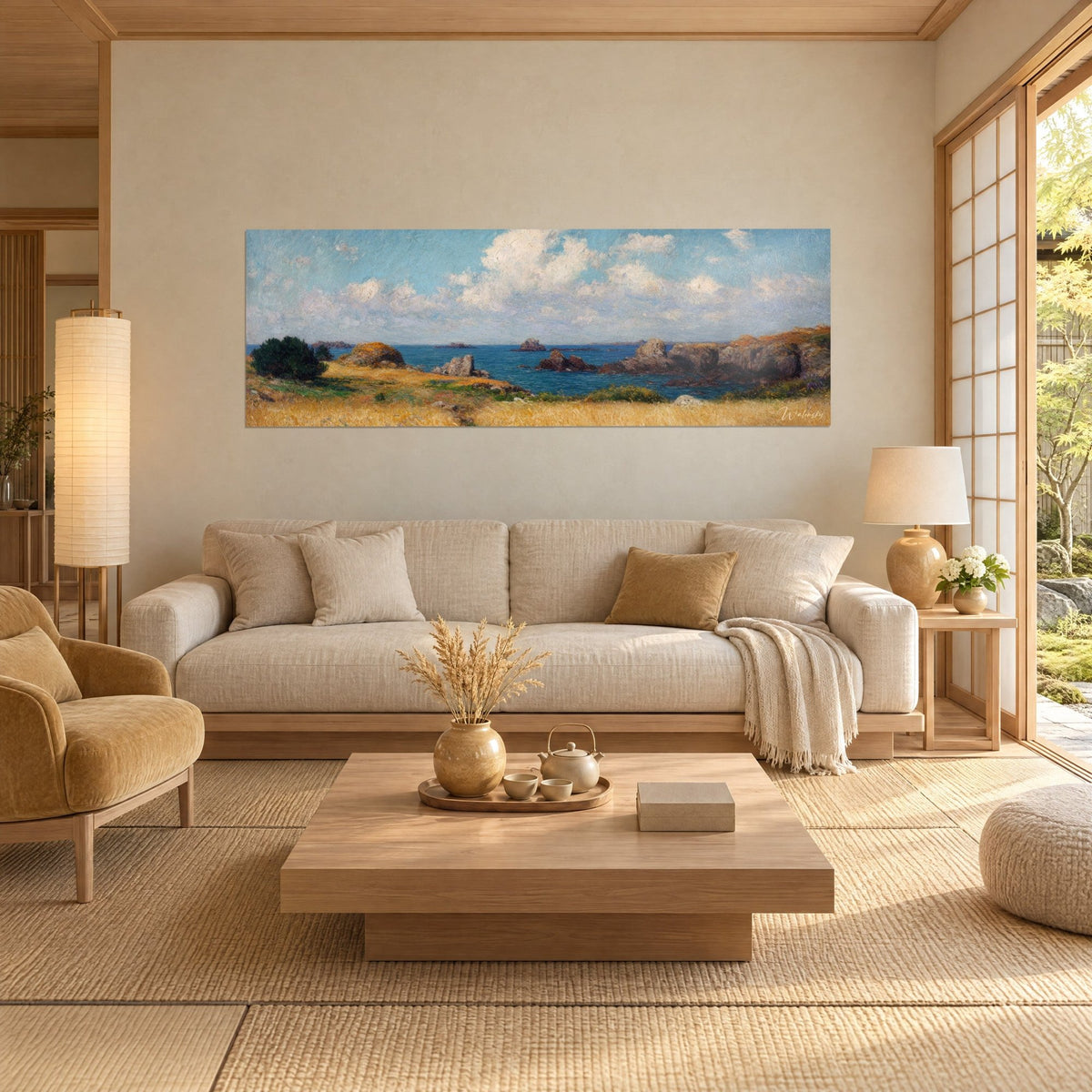 Gemälde Felsenküste der Bretagne mit goldenen Felsen, tiefblaues Meer und weiße Wolken, über einem Sofa in einem hellen Wohnzimmer
