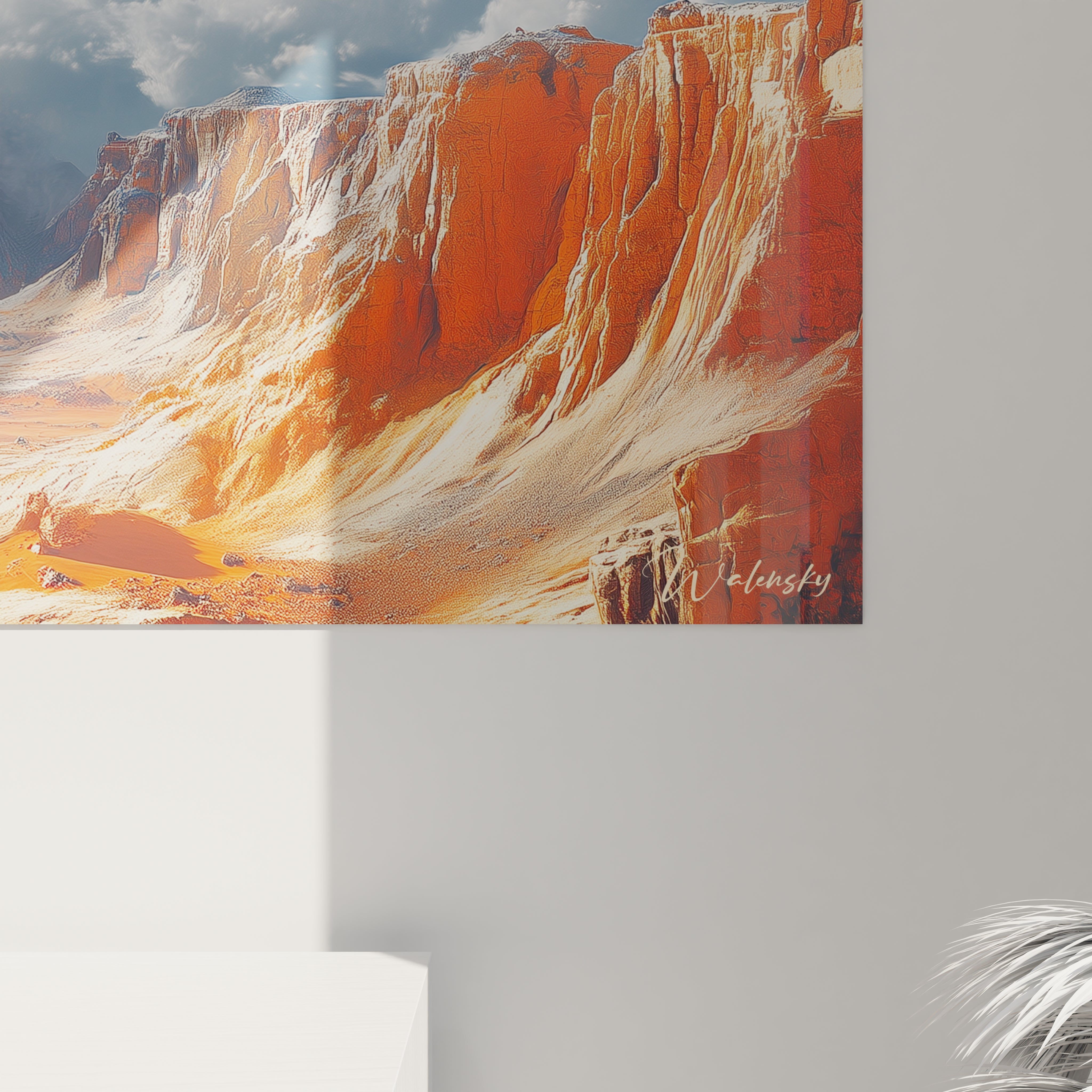 Un tableau montagne présentant un paysage désertique aux impressionnantes falaises stratifiées de couleur rougeâtre et ocre, dominant une plaine aride, avec un horizon lointain baigné de lumière sous un ciel bleu parsemé de nuages blancs cotonneux.