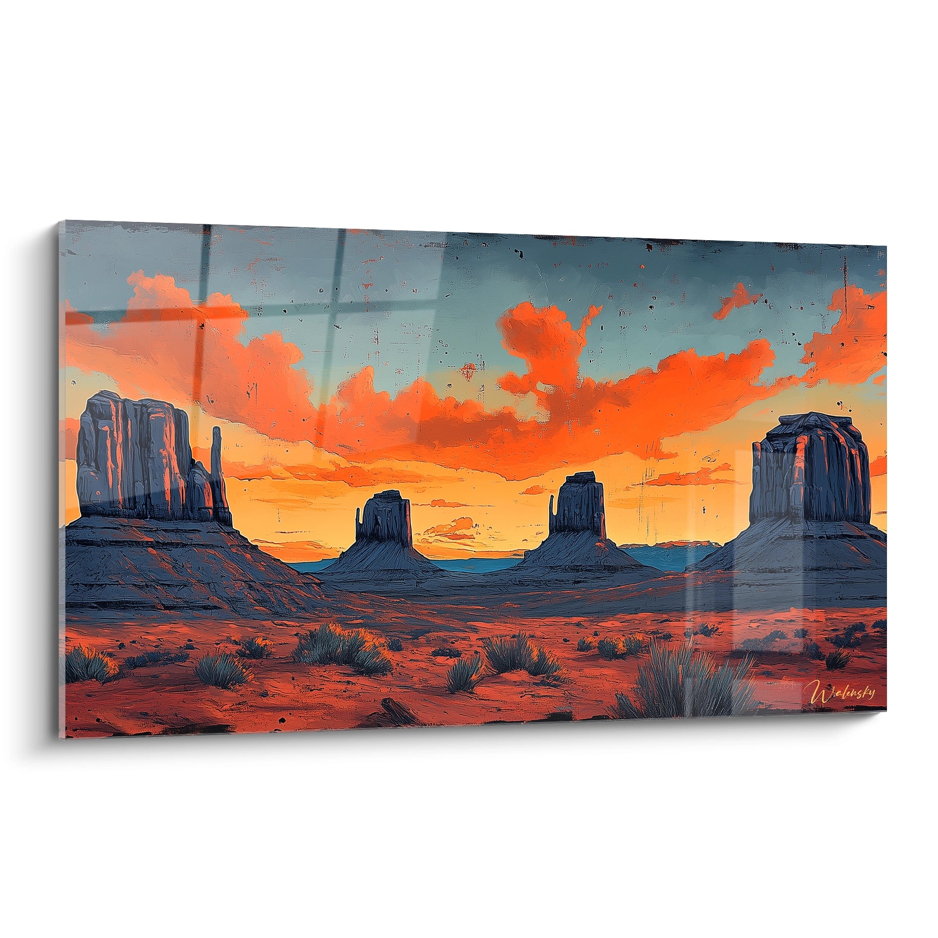 Un tableau désert représentant quatre buttes rocheuses monumentales sous un ciel embrasé d'orange et de bleu, avec une végétation éparse au premier plan.
