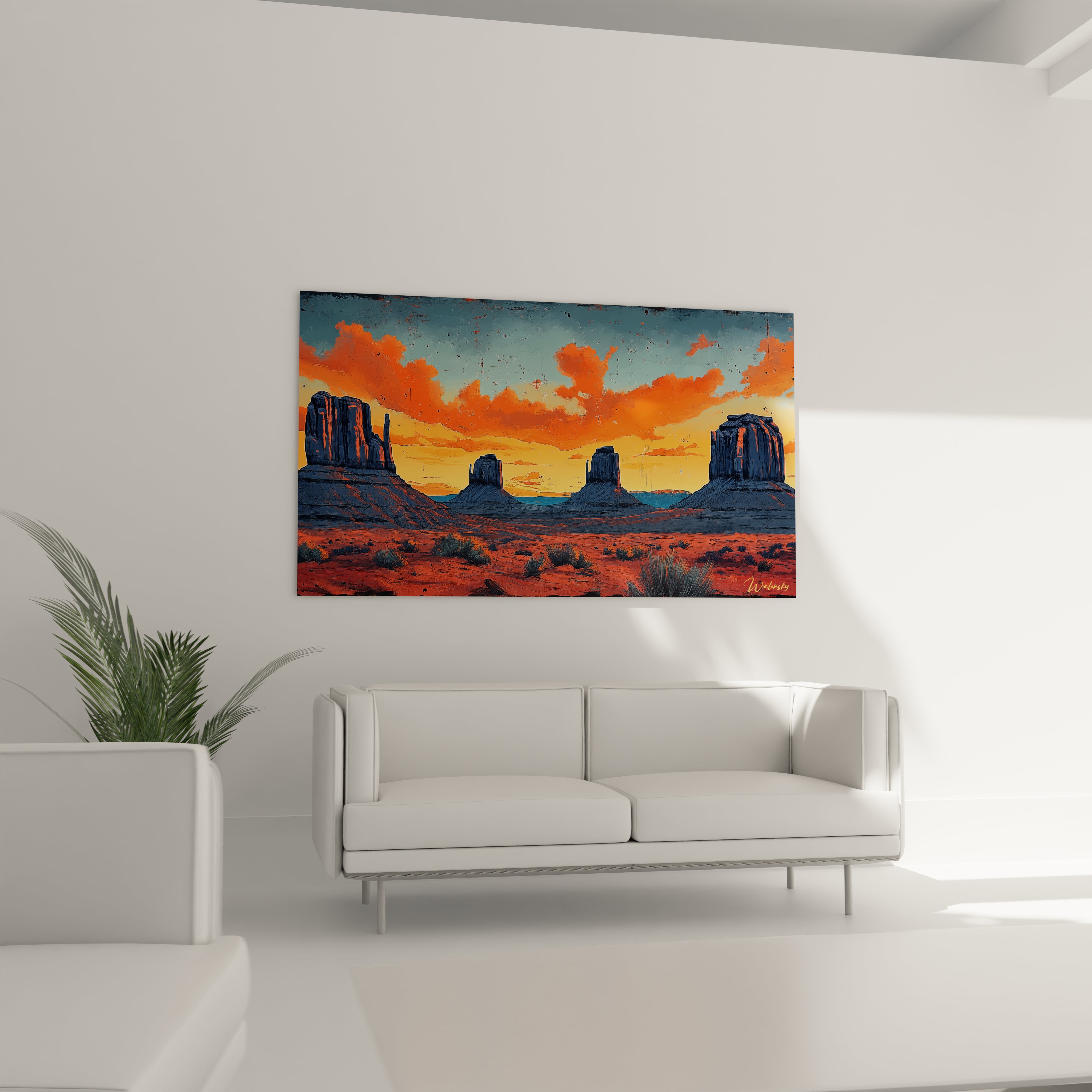 Vue panoramique d'un tableau désert montrant des mesas iconiques, un ciel orangé intense et des touches de végétation désertique sur fond de paysage aride.
