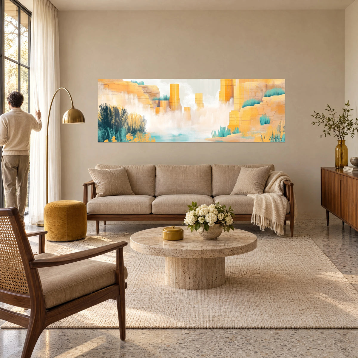 Wall art golden sandstone cliffs over turquoise water, white mist and blue-green grasses, above a sofa in a bright living room