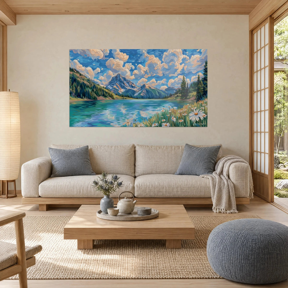 Wall art turquoise mountain lake beneath swirling cream clouds, bluish peaks and dark pines, hanging above a sofa in a bright living room