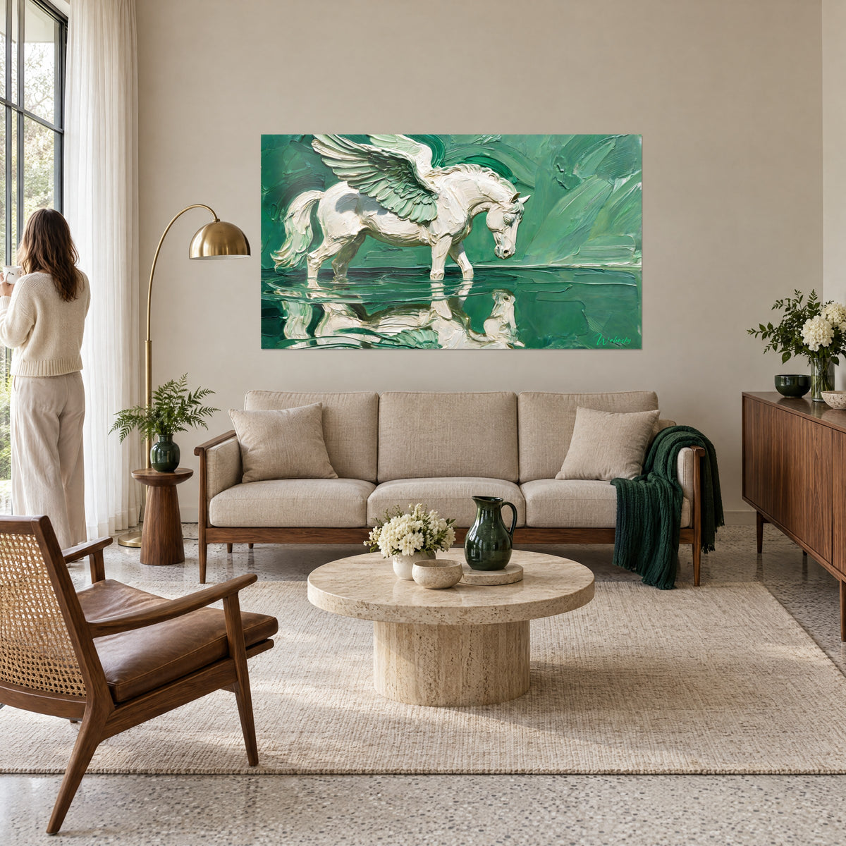 Wall art of a cream-white winged horse with sage-green feathered wings, leaning over water, above a sofa in a bright living room