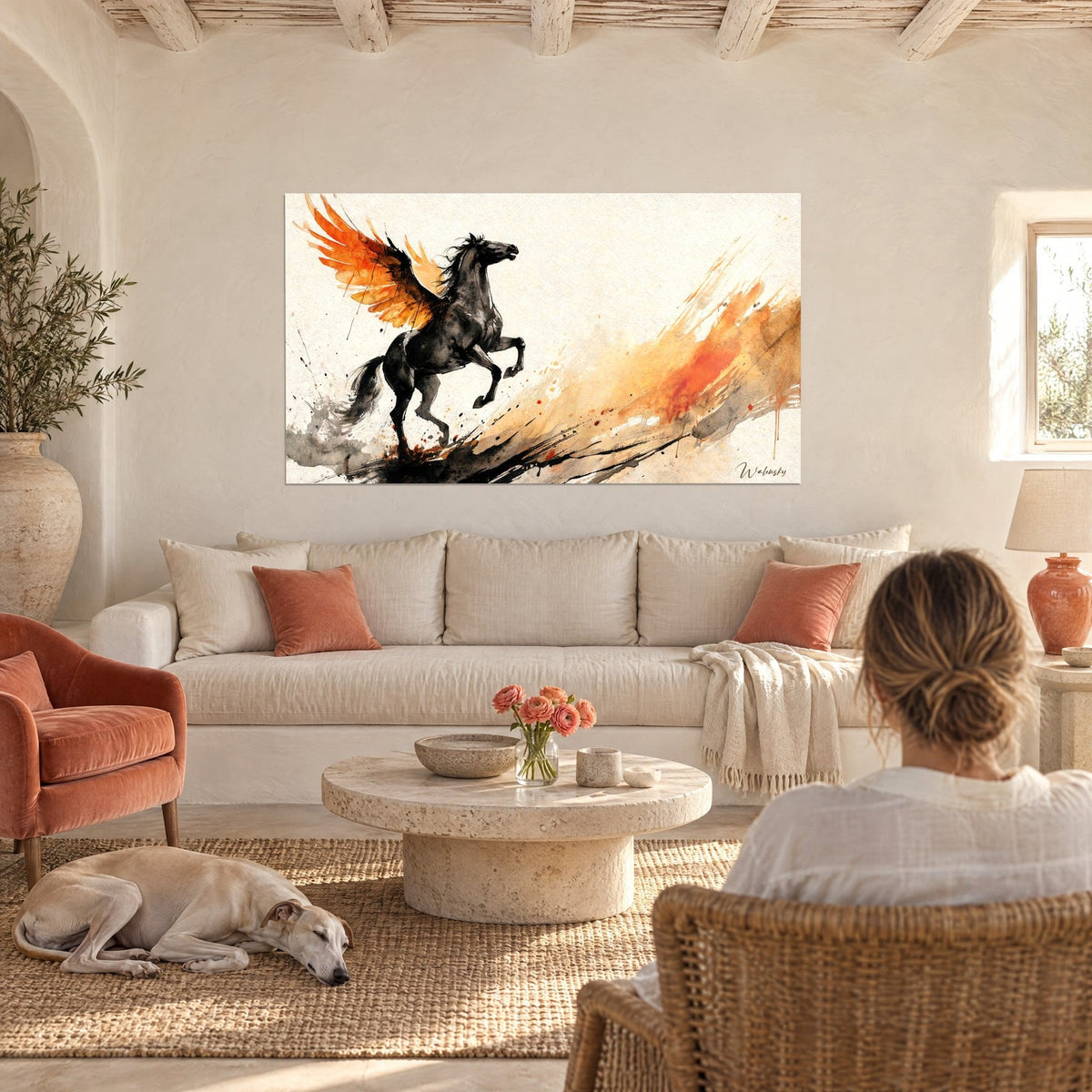 Tableau cheval noir cabré aux ailes orange flamboyantes, traînée d'encre ocre, une femme de dos et un greyhound au-dessus d'un canapé dans un salon lumineux