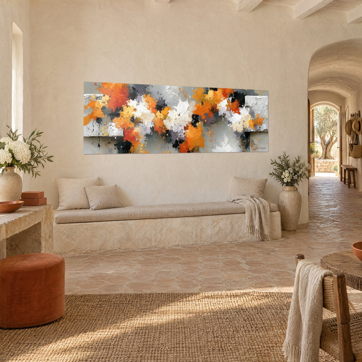 Wall art with a painterly burst of saffron orange and coal black on a pearl grey background, angled view, above a stone bench