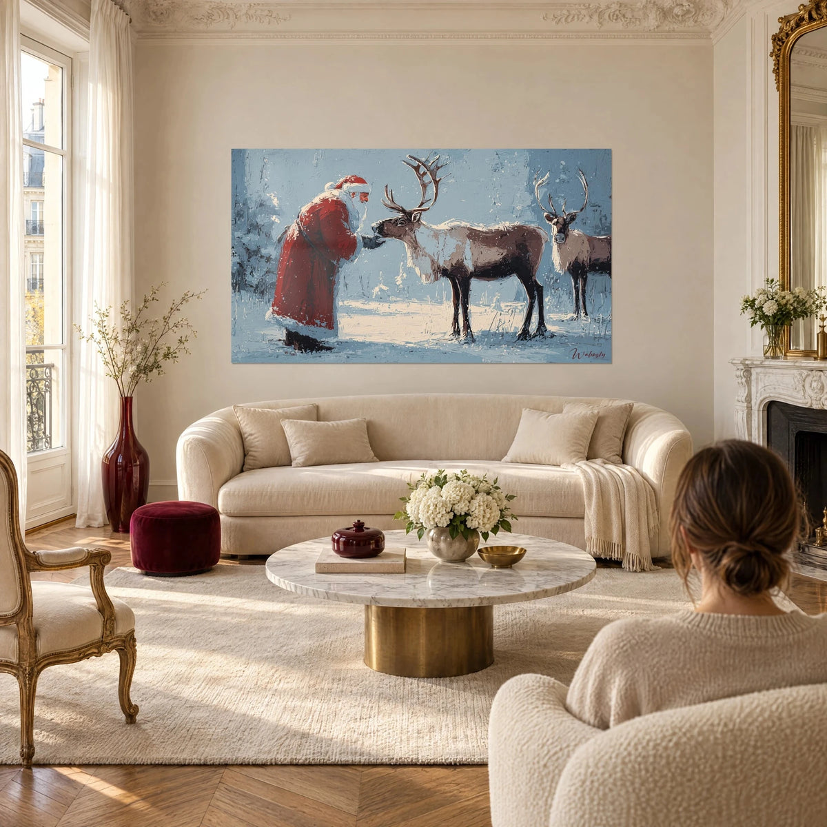 Wall art Santa Claus in a red coat holding out his hand to a brown reindeer, blue-grey snow, above a sofa in a bright living room