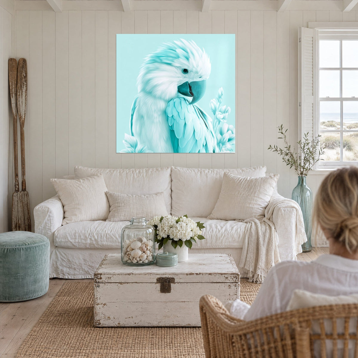 Wall art white cockatoo with fluffy crest, turquoise beak, pale flowers, above a sofa in a bright living room
