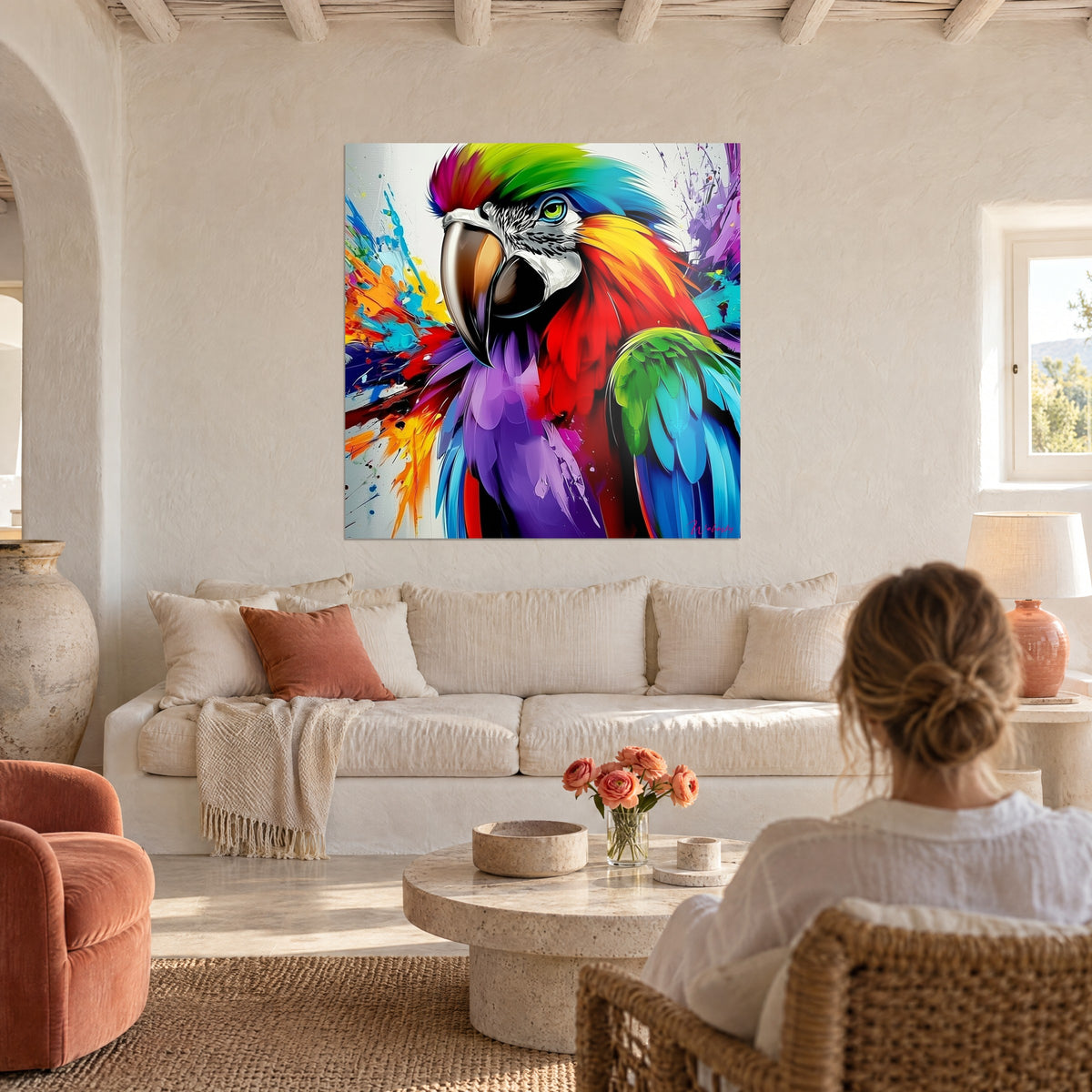 Tableau ara éclaboussé de rouge vif et de bleu turquoise, crête arc-en-ciel, au-dessus d'un canapé dans un salon lumineux