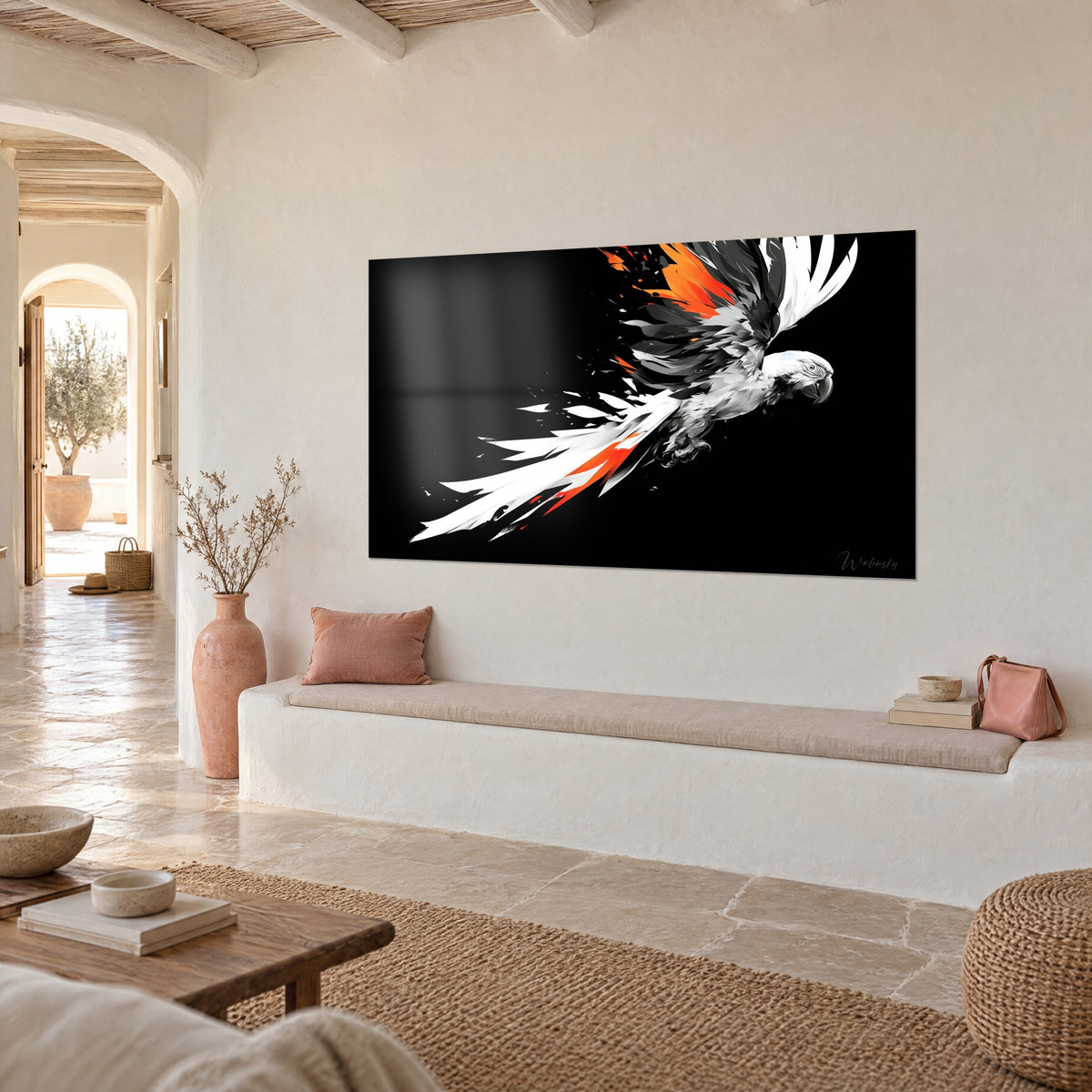 Wall art of an exotic bird in flight, grey and white wings speckled with orange, deep black background, seen three-quarter view in a corridor with a pale stone vaulted ceiling