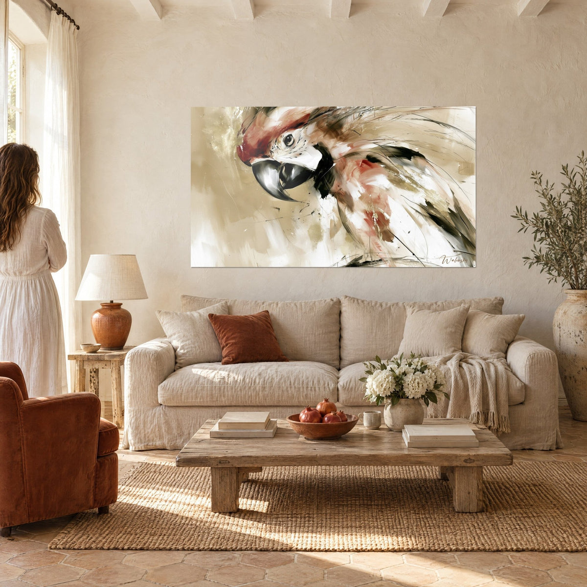 Wall art side-profile macaw with half-open black beak, rust and cream feathers, couple seen from behind above a sofa in a bright living room
