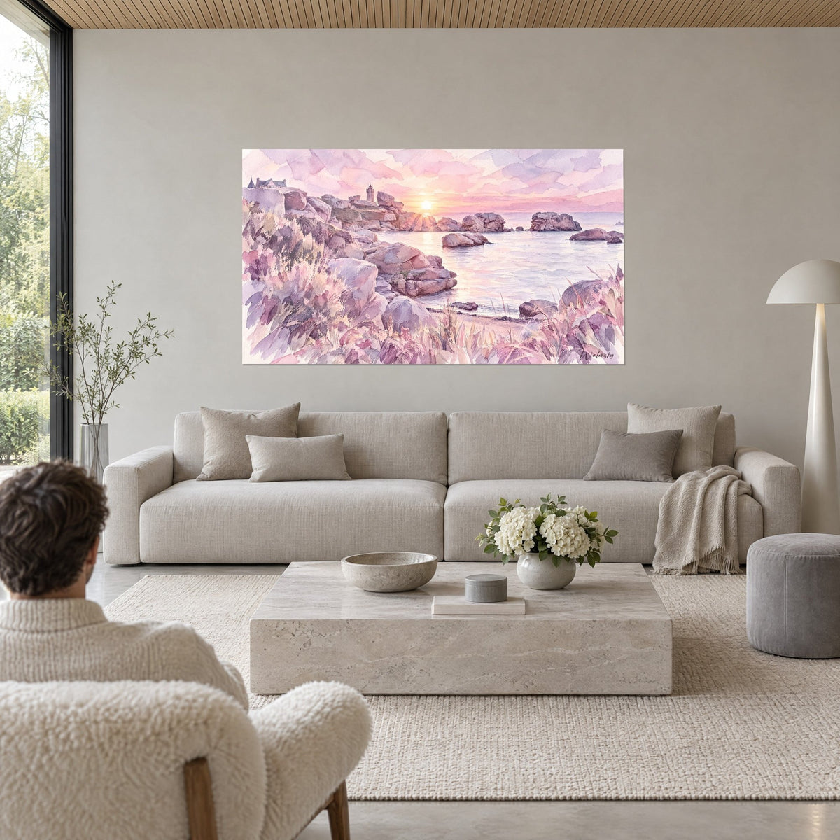 Cuadro granito rosa al atardecer, faro lejano, agua lila y cielo malva, sobre un sofá en un salón luminoso