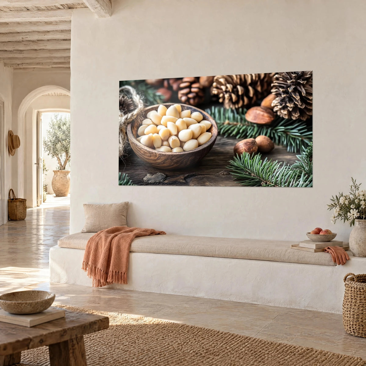 Schilderij van crèmekleurige pijnboompitten en bruine dennenappels, groene sparrentakken, opgehangen aan een witte muur van een mediterraan huis