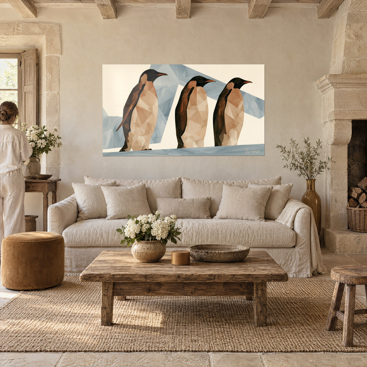 Tableau trio de manchots bruns au bec orangé sur fond crème et bleu givré, salon de pierre, au-dessus d'un canapé dans un salon lumineux