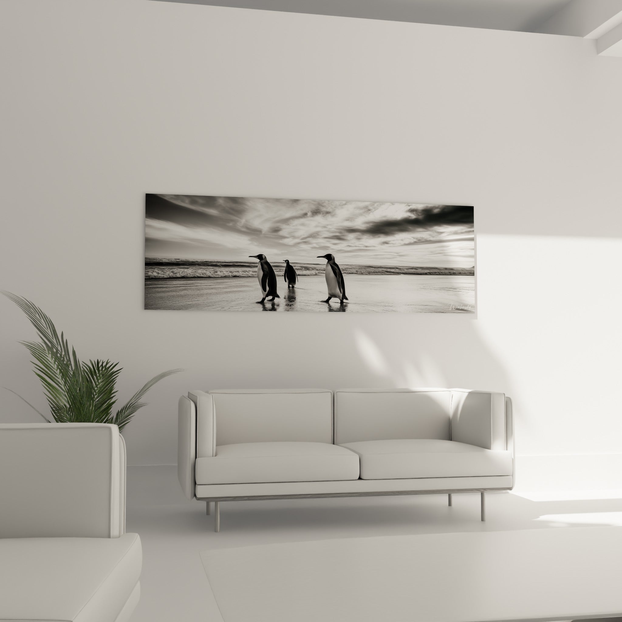 Trio de pingouins gris et noirs longeant l'écume, accroché au-dessus d'un canapé dans un salon lumineux