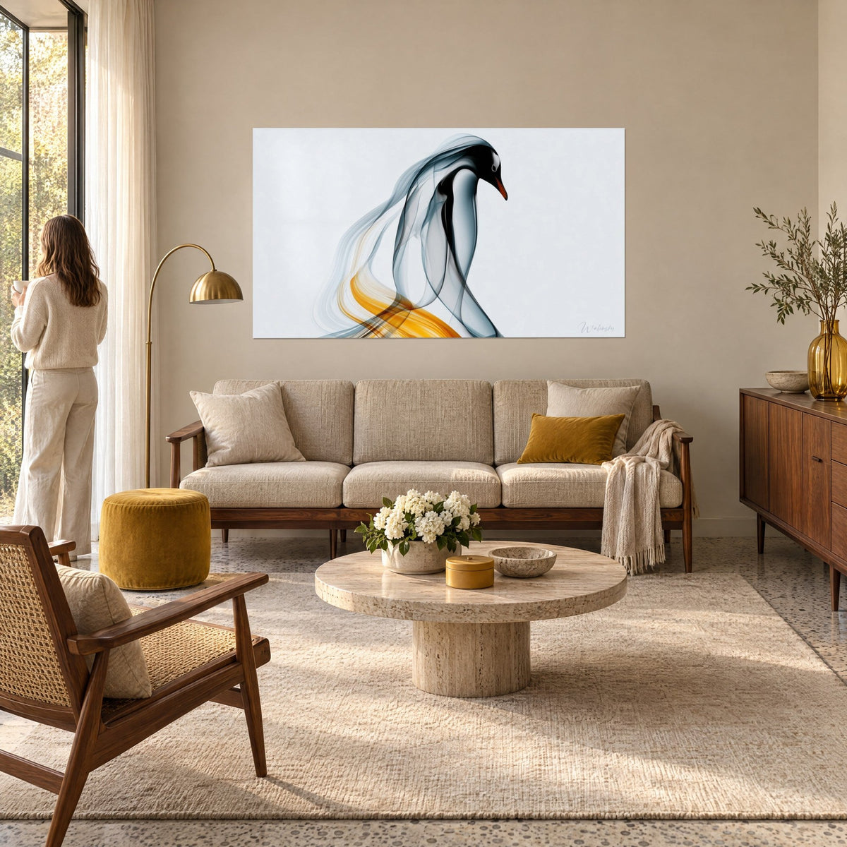 Tableau pingouin de fumée grise aux voiles ondulants et reflets ambre, femme de dos, au-dessus d'un canapé dans un salon lumineux