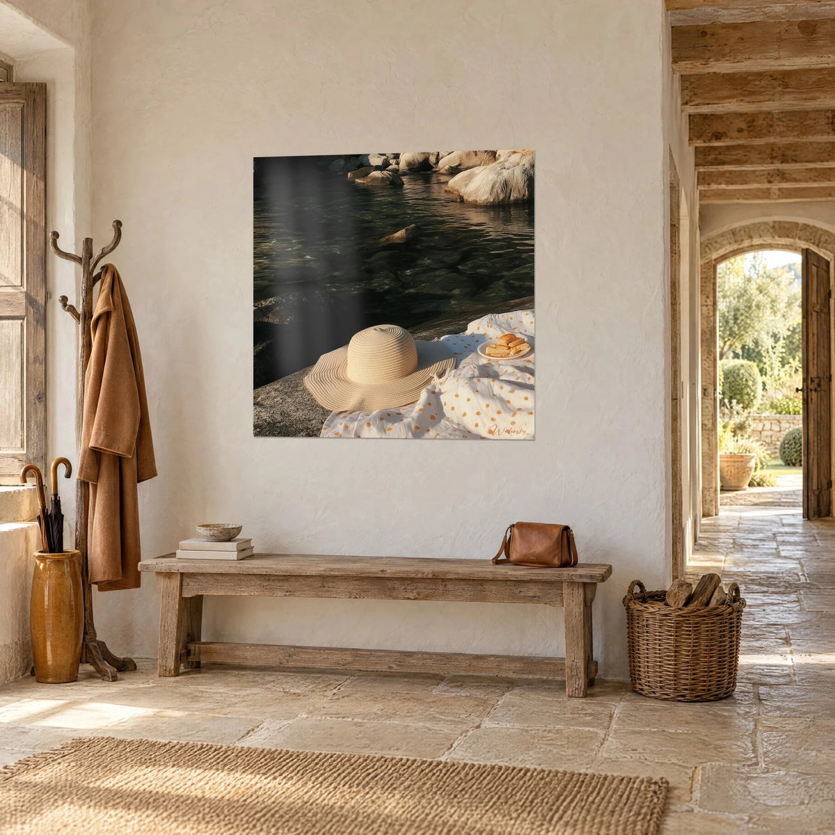 Wall art with cream raffia panama hat on a grey rock near green water, golden picnic, entrance of a stone house