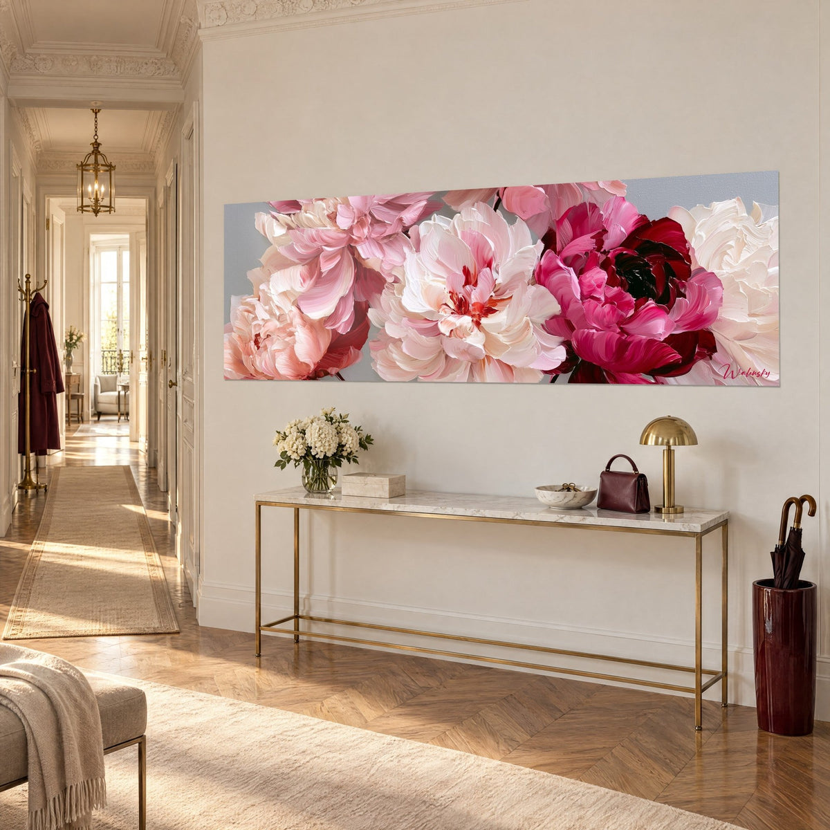 Wall art of five large creamy and magenta flowers on a pearl grey background, thick brushstrokes, above a gilded console in three-quarter view