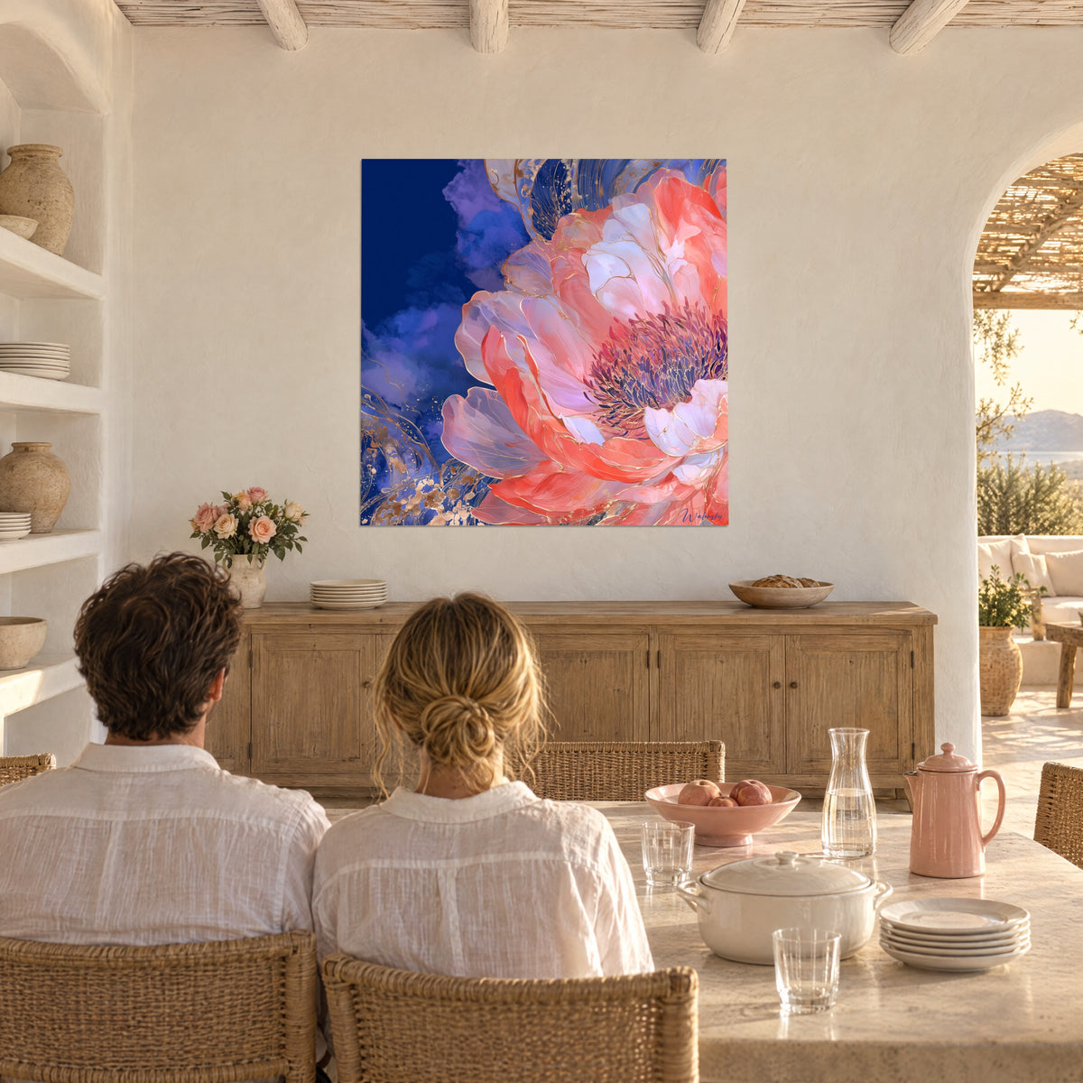 Wall art giant pale pink and coral red corolla, gold threads on cobalt background, a couple seen from behind, limewashed wall beside a table