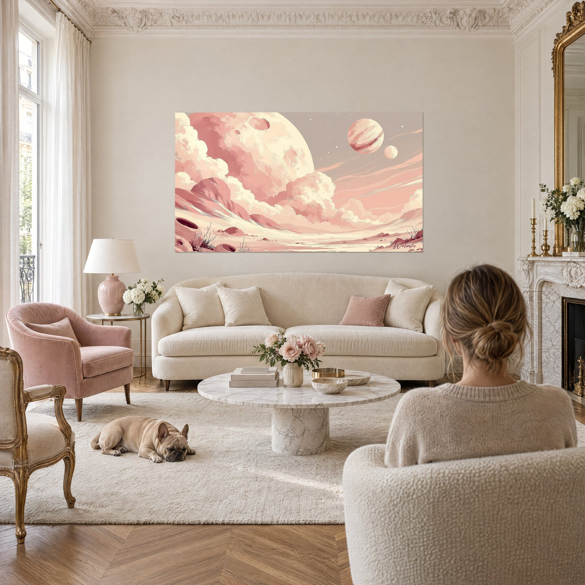 Wall art giant cream planet striped with pink, two small moons, misty clouds, above a sofa in a bright living room