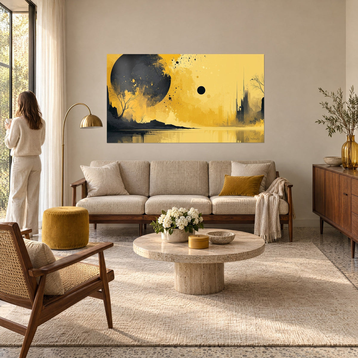 Cuadro planeta oscuro salpicado de negro sobre cielo amarillo mostaza, árbol desnudo reflejado, encima de un sofá en un salón luminoso