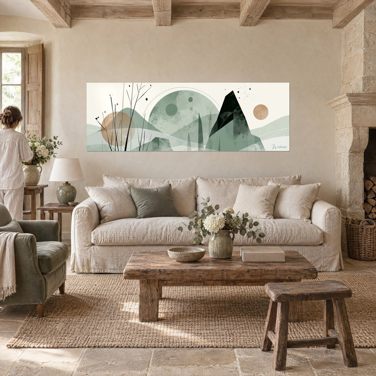 Wall art large sage moon and sharp black mountain, beige sun, fine branches, a person seen from behind, above a sofa in a bright living room