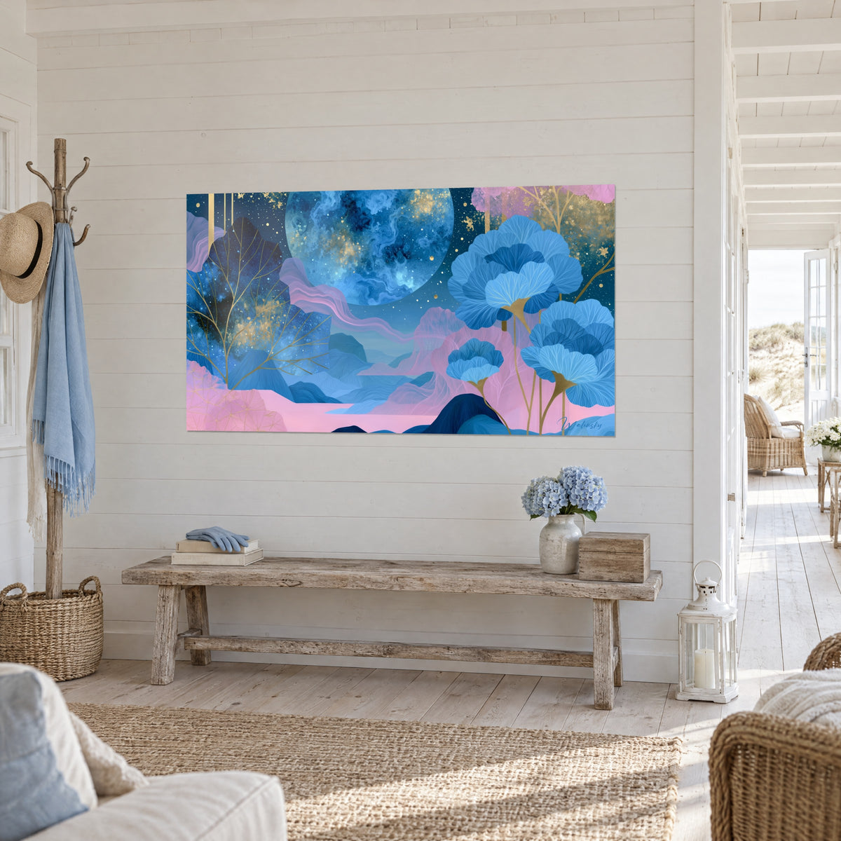 Wall art midnight blue moon veined with gold, large azure ginkgo flowers and pink hills, hung in the entrance of a seaside house