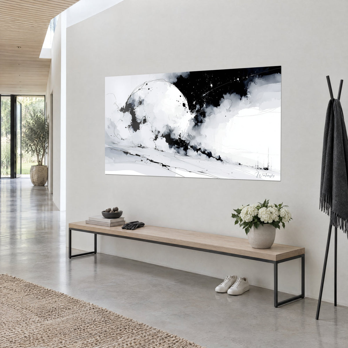 Wall art milky celestial body outlined by a fine line, black ink splatters on white background, seen three-quarter view on a beige wall