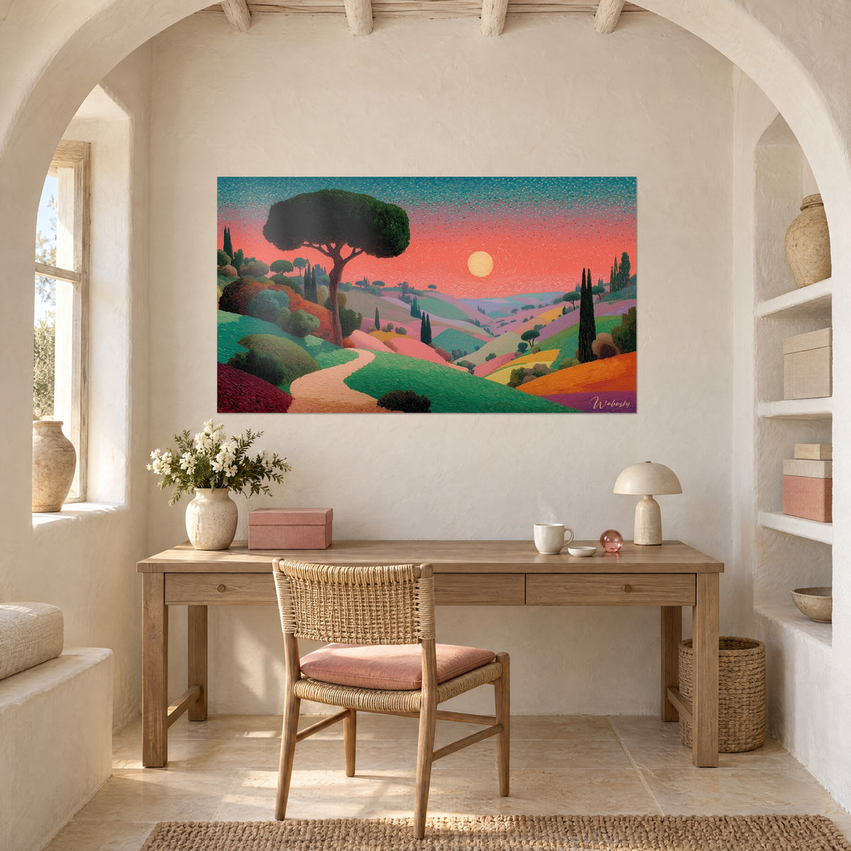 Wall art Tuscan valleys in pink and emerald, dotted coral red sky, round sun, hung above a light wood desk