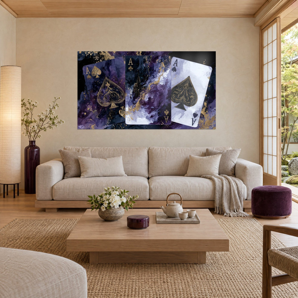 Wall art with three ace of spades with golden veins on a night violet background, above a sofa in a bright living room