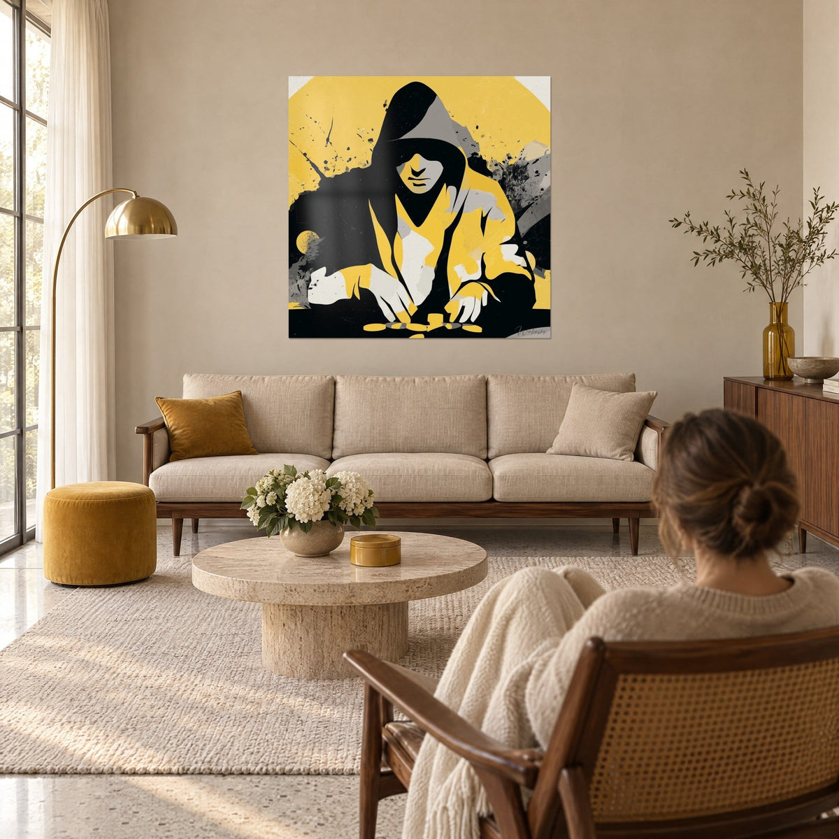 Wall art of a hooded poker player, black hood and yellow jacket, gold chips, a woman seen from behind, above a sofa in a bright living room