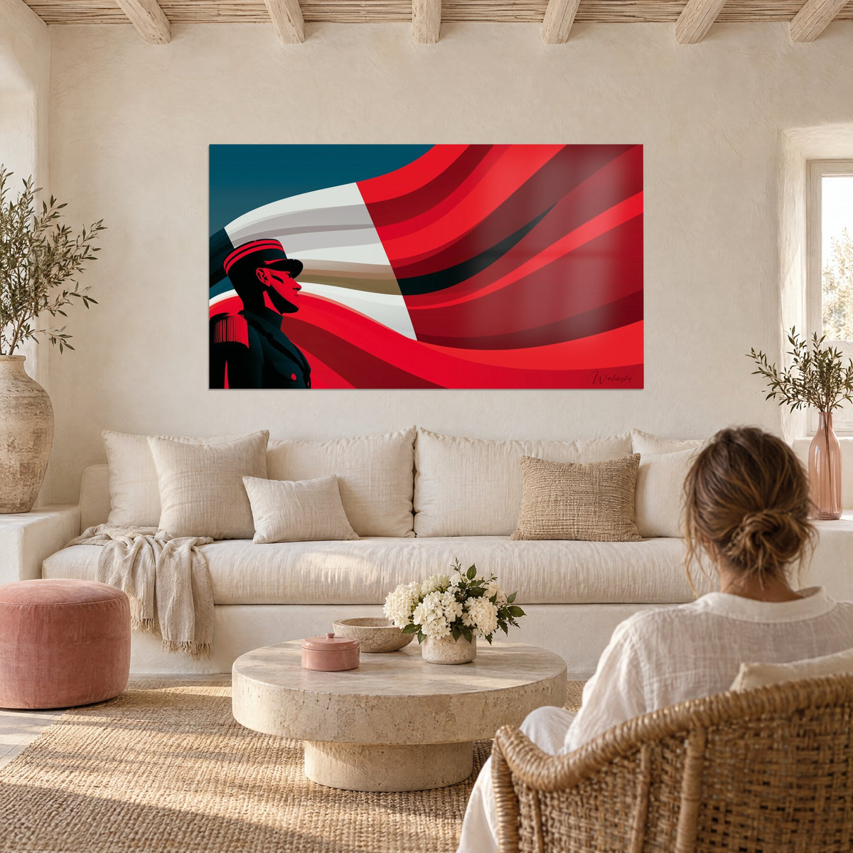 Wall art officer in black peaked cap in front of a rippling red and white flag, hung above a sofa in a bright living room