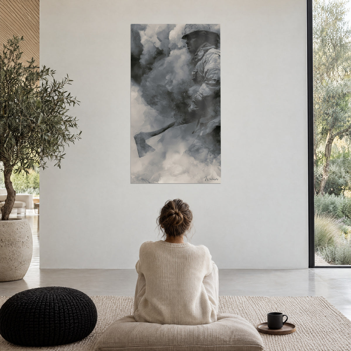 Wall art fireman and his axe emerging from a cloud of charcoal and light grey, woman seen from behind seated on a pouf near a bay window