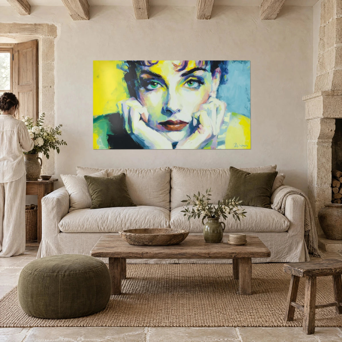 Wall art woman's face with green eyes, lemon yellow and sky blue background, hands clasped, above a sofa in a bright living room