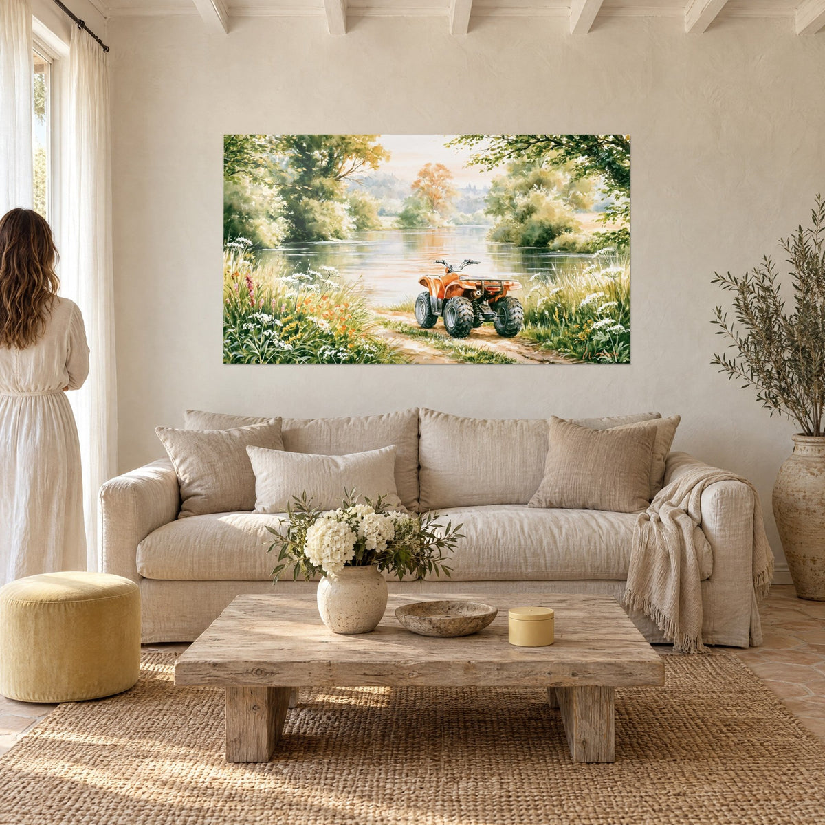 Wall art: orange quad bike parked on an ochre dirt track, silver river and green foliage, above a sofa in a bright living room