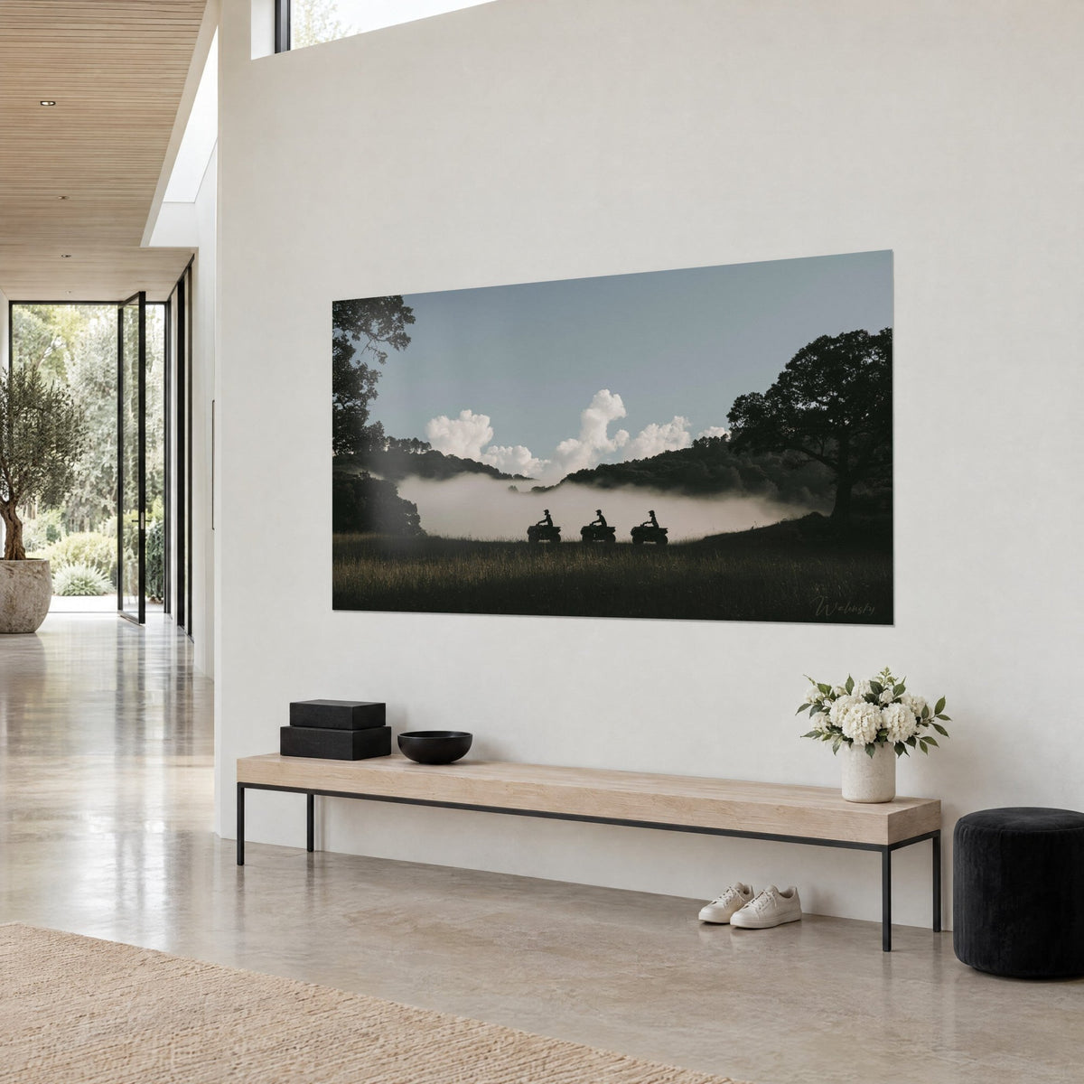 Wall art riders on off-road vehicles in a veil of mist, dark oak and white cumulus clouds, beige wall of an architect's house