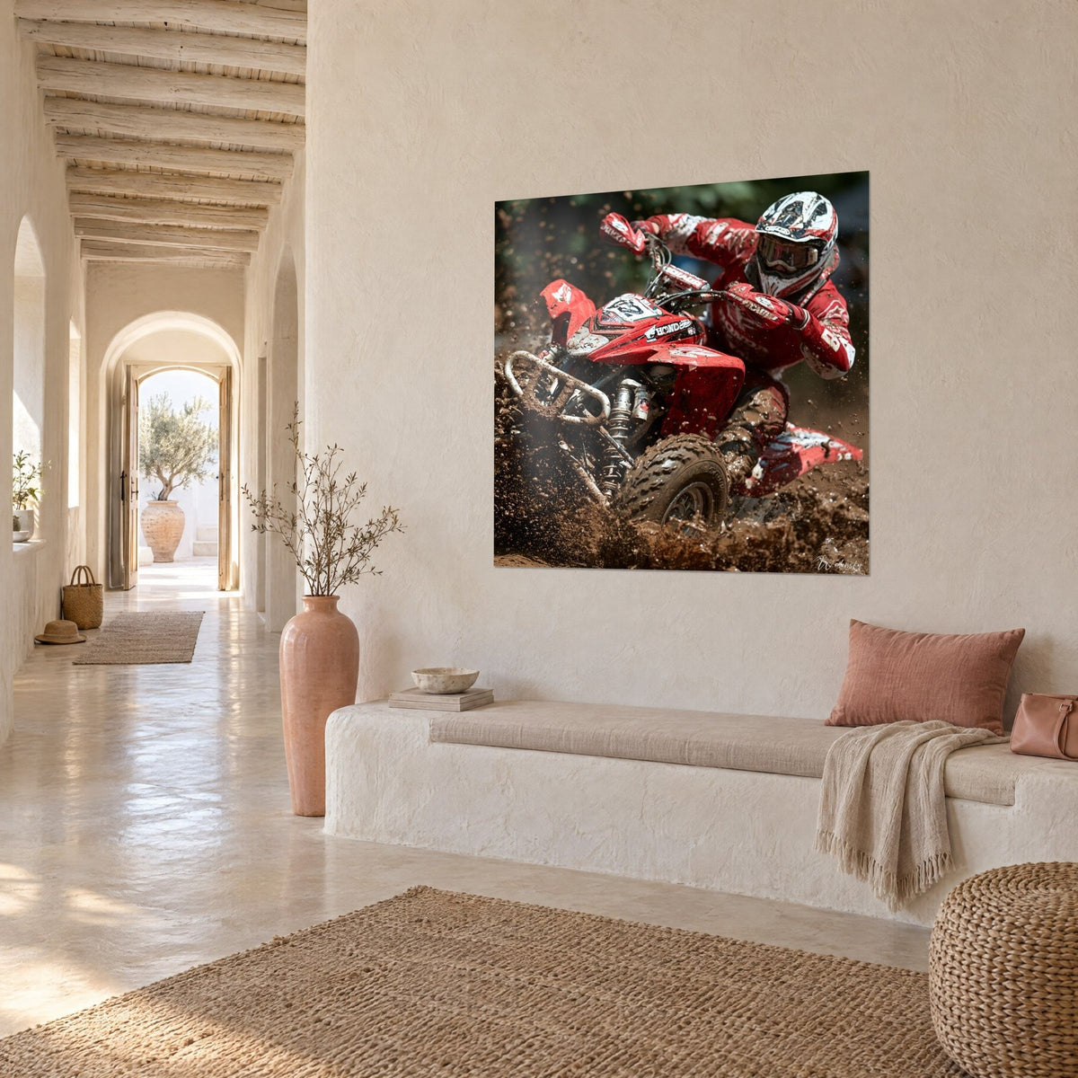 Wall art of a quad rider in a scarlet suit with white patterns, clumps of earth flying, hung in a vaulted corridor of pale stone