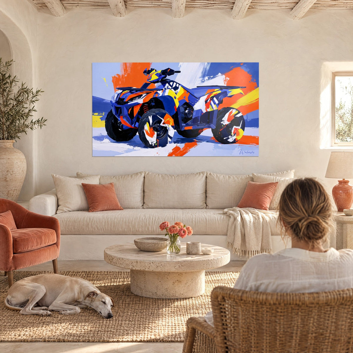 Wall art indigo blue all-terrain quad with orange lightning bolts on a lavender background, a woman seen from behind and a greyhound above a sofa in a bright living room
