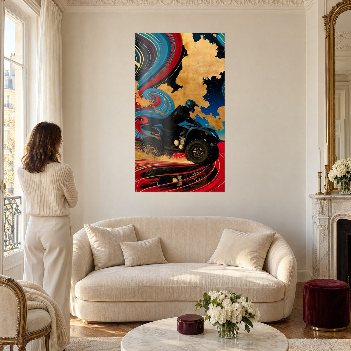Wall art helmeted quad rider racing through golden sand, turquoise and red swirls, woman seen from behind, above a sofa in a bright living room