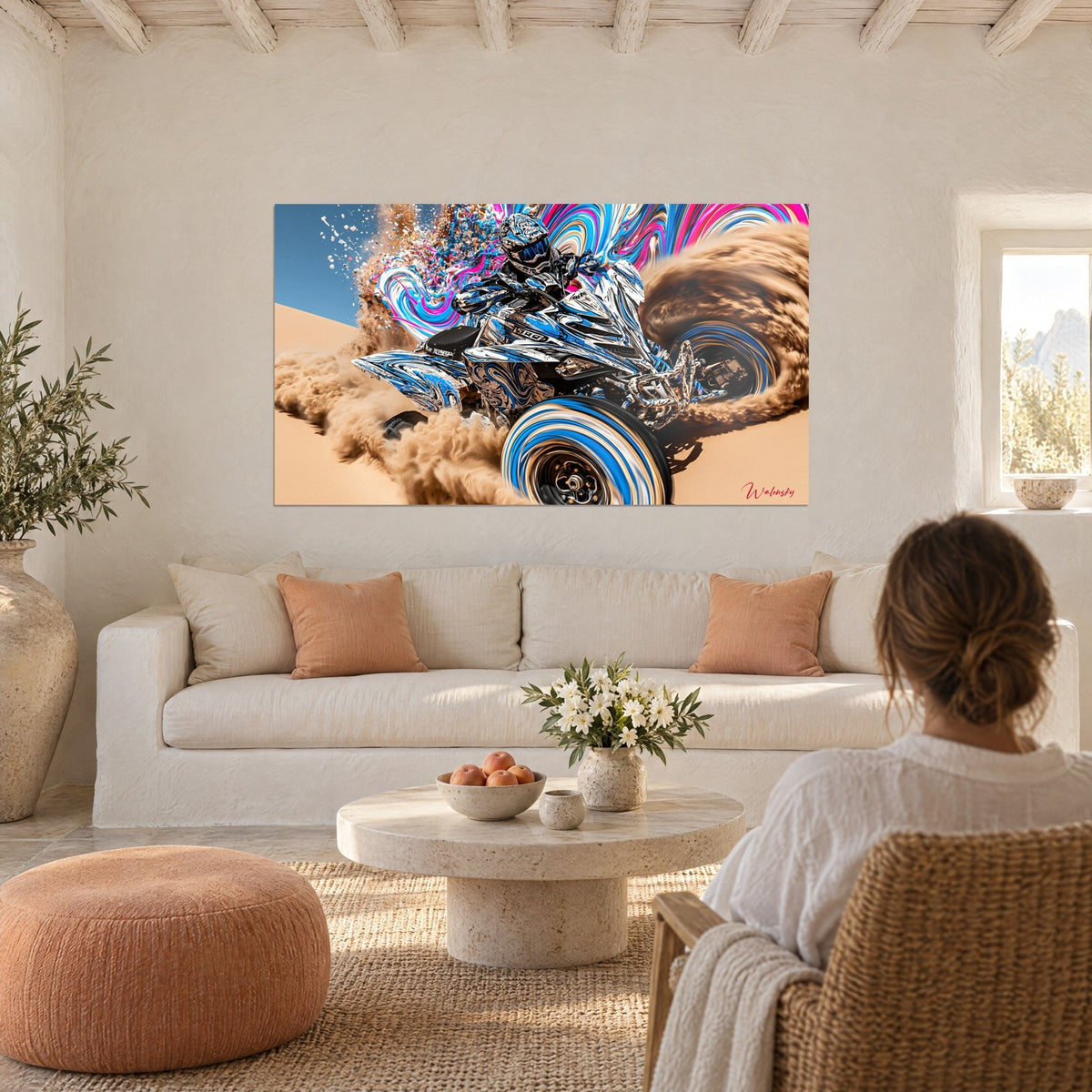 Wall art chrome-effect quad in blue and white skidding over the dune, spraying brown sand, above a sofa in a bright living room