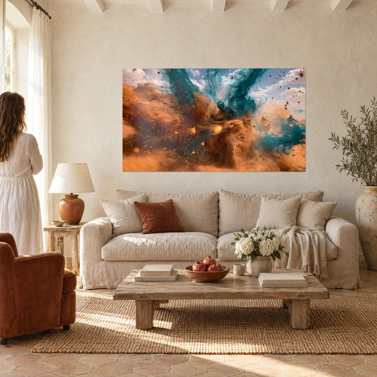 Wall art quad rider bursting out of a spray of ochre sand and turquoise dust, headlight on, above a sofa in a bright living room