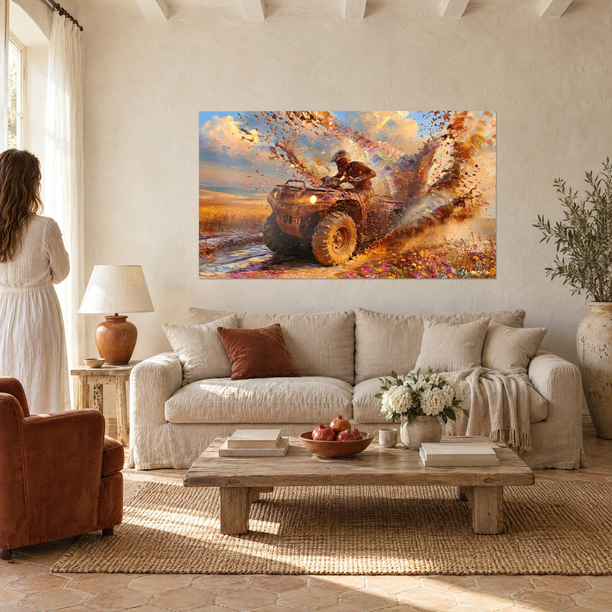 Wall art of a golden quad bike ploughing through mud, brown spray and pale blue and cream sky, couple seen from behind above a sofa in a bright living room