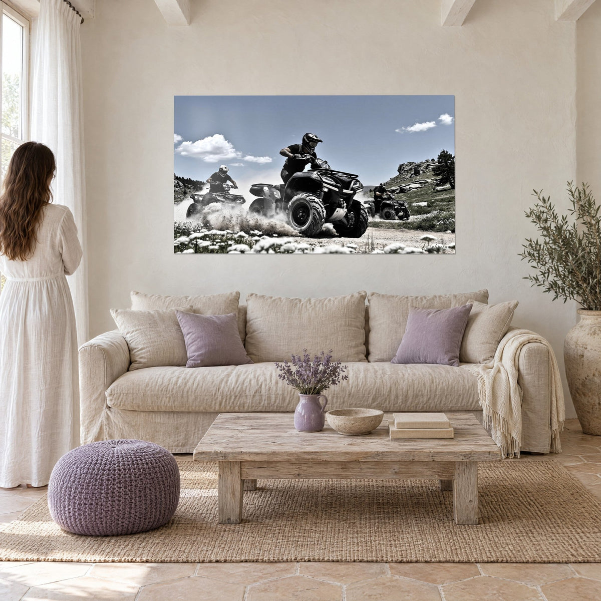 Wall art of a black quad bike leaping through a cloud of dust, blue sky and white daisies, above a sofa in a bright living room
