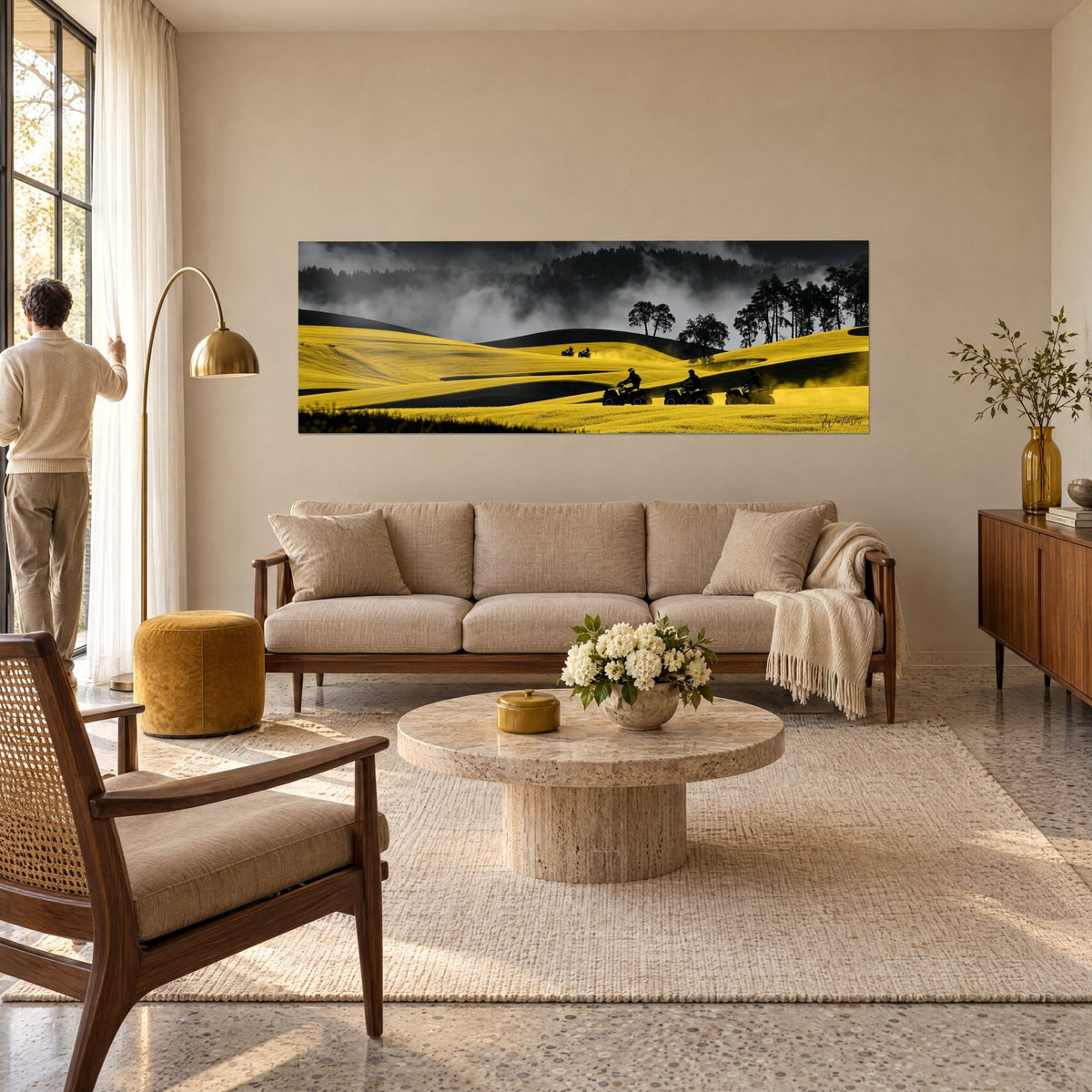 Wall art four quad riders racing over hills of lemon-yellow rapeseed and black, grey mist, above a sofa in a bright living room