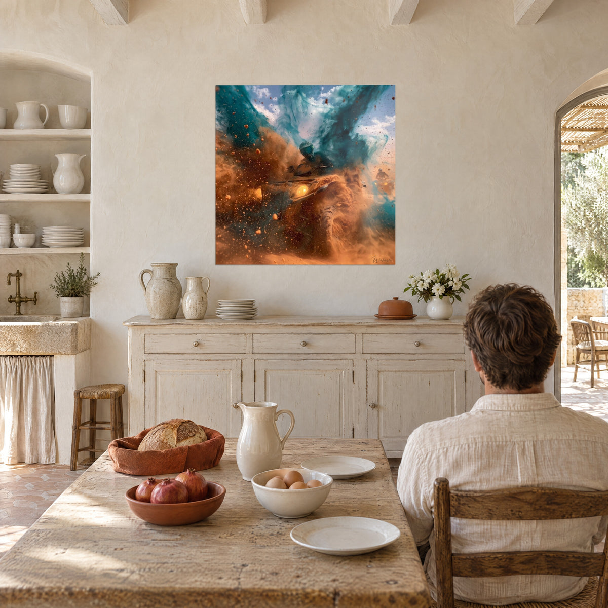 Wall art of a desert race, orange earth spraying against a cloudy blue sky, facing a light stone table