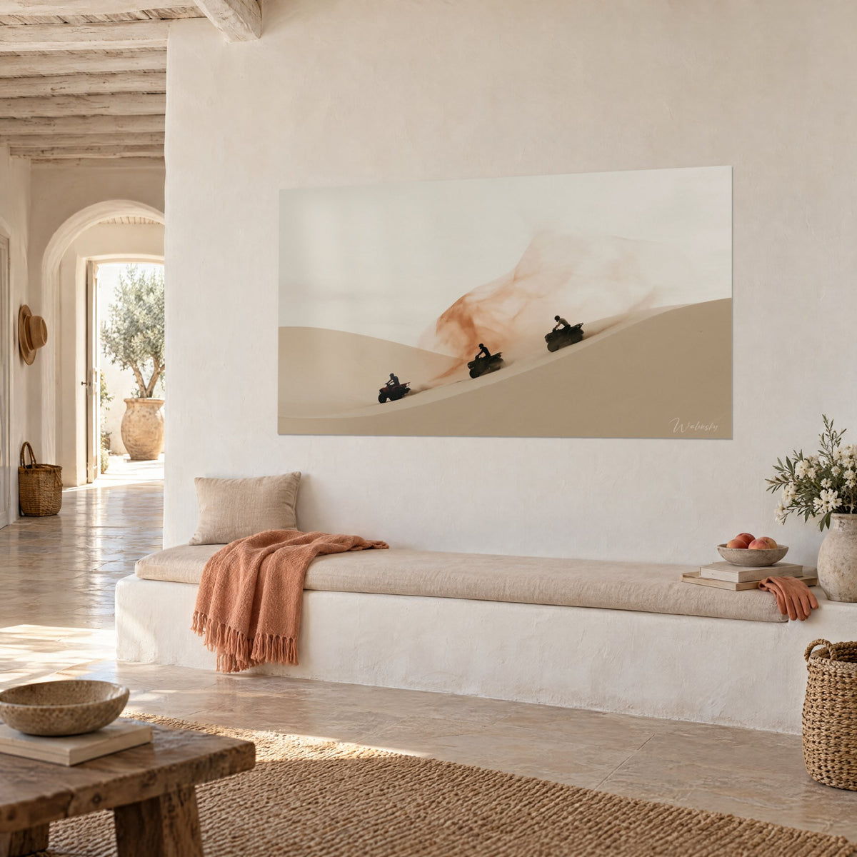 Wall art pilots in silhouette on an ivory sand ridge, rust-colored trail across the pale sky, white banquette, Mediterranean house