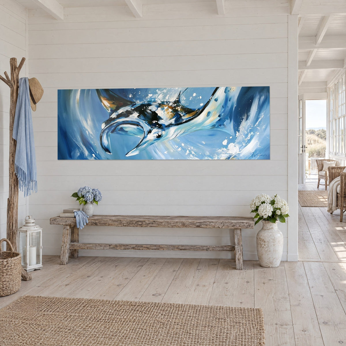 Tableau poisson aux ailes déployées, bleu ciel et noir, queue en spirale, mur blanc lambrissé d'une maison de bord de mer