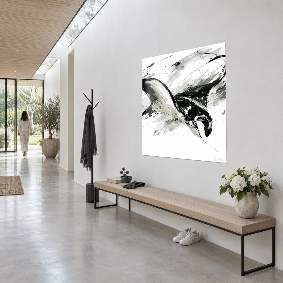 Wall art oceanic manta ray with ivory and ink-black wings, gray splashes, hung in a hallway shot at three-quarter angle