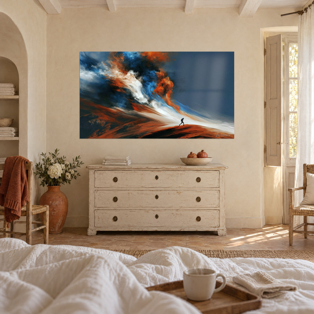 Wall art mountaineer in silhouette under a navy sky, orange and white swirls, hung above a bed in a light bedroom