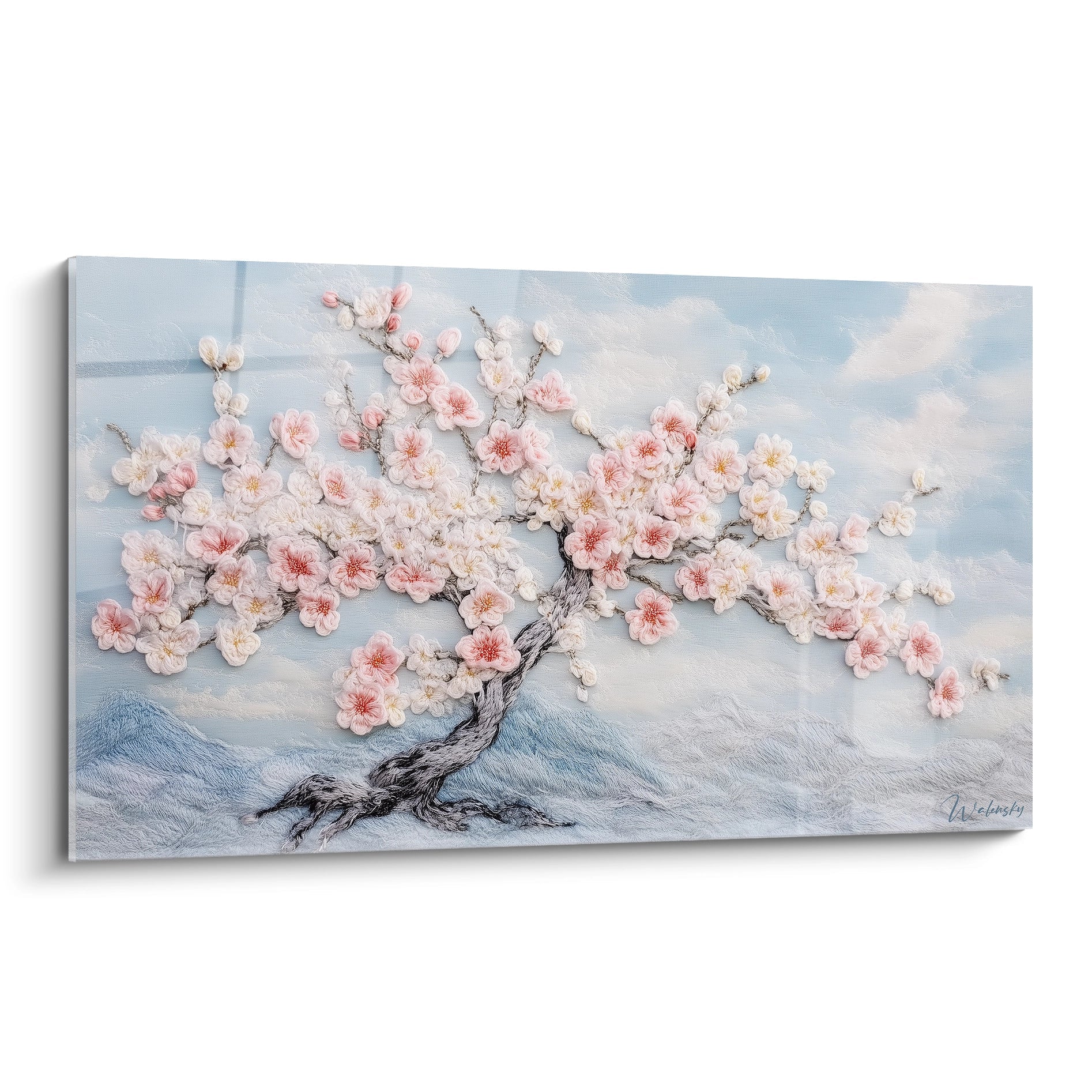 Un tableau en relief représentant un cerisier en fleurs avec tronc tortueux et branches étalées, offrant des fleurs roses et blanches en relief texturé sur fond bleu ciel avec montagnes brumeuses, créant une atmosphère printanière sereine.
